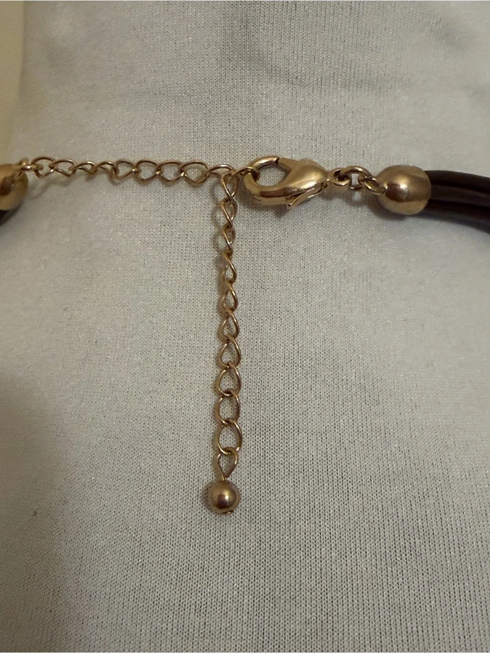 Gold Textured Oval Pendant Necklace with Brown Pleather Multi String Chain.